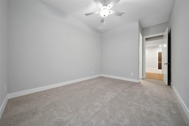 empty room with light colored carpet and ceiling fan