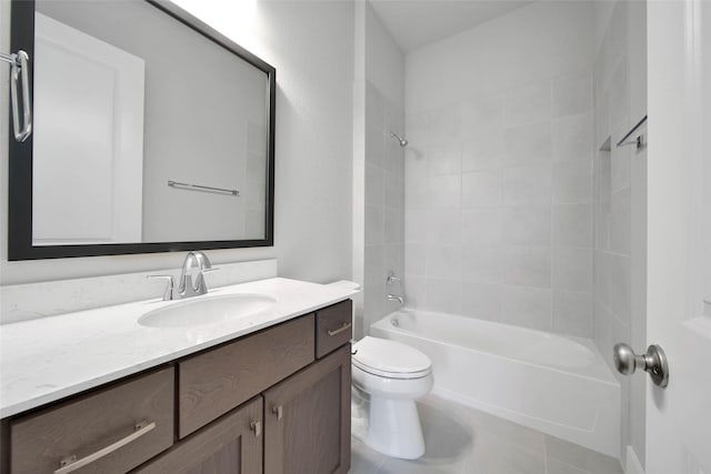 full bathroom featuring vanity, tile patterned flooring, toilet, and tiled shower / bath