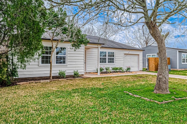 view of front of home with a garage and a front lawn