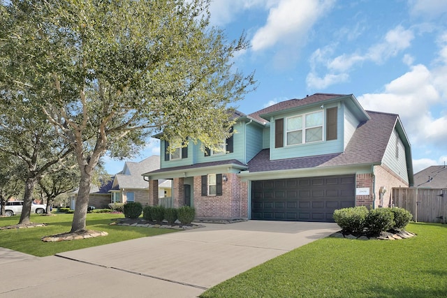 traditional-style house with brick siding, an attached garage, concrete driveway, and a front yard