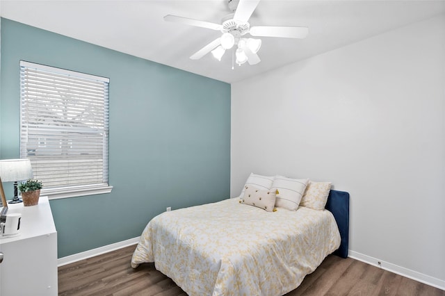 bedroom with ceiling fan and dark hardwood / wood-style flooring