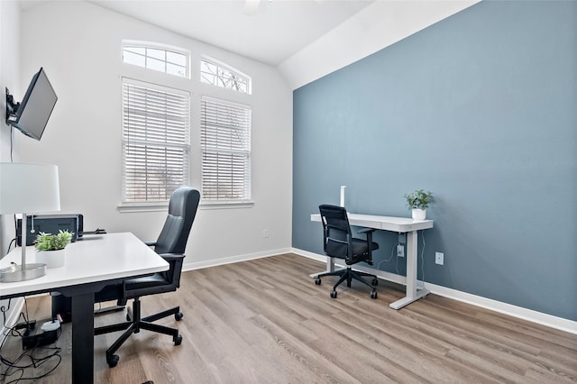 office featuring lofted ceiling and light wood-type flooring