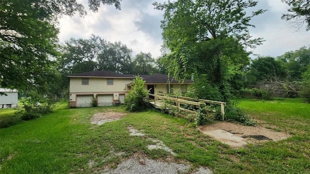 exterior space with a garage, driveway, and a front lawn