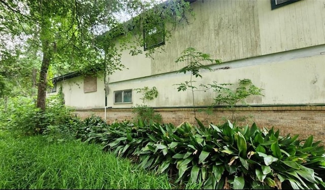 view of side of home featuring brick siding