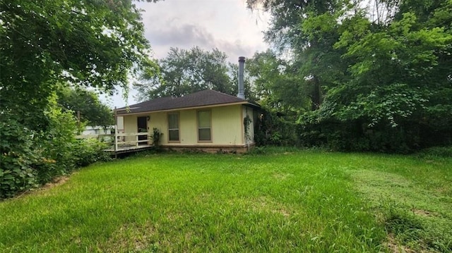 rear view of property featuring a lawn