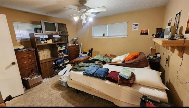 bedroom featuring light carpet and a textured ceiling