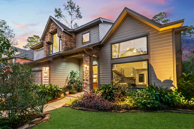 view of front of property with a garage and a yard