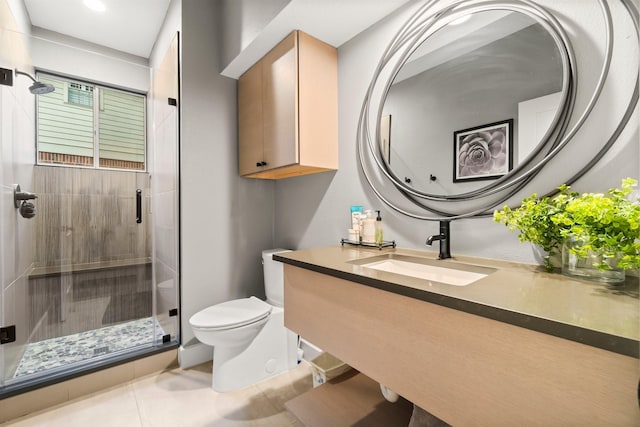 bathroom with an enclosed shower, vanity, tile patterned floors, and toilet