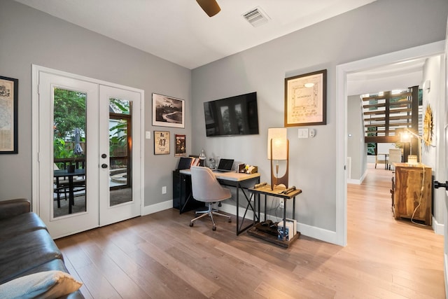 home office with french doors, ceiling fan, and light hardwood / wood-style floors