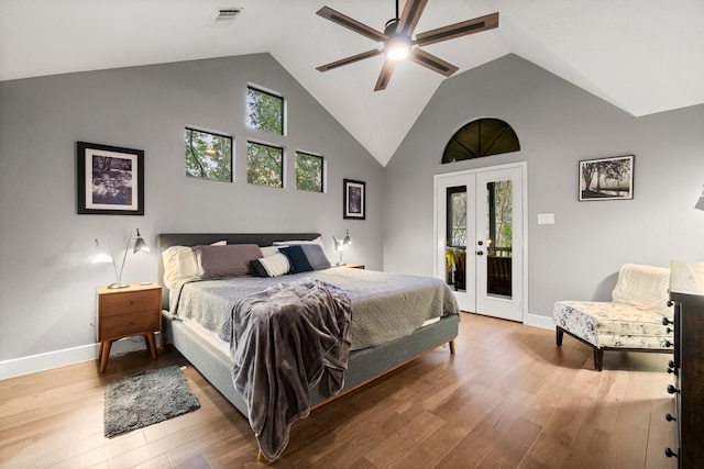 bedroom with french doors, wood-type flooring, access to exterior, and multiple windows