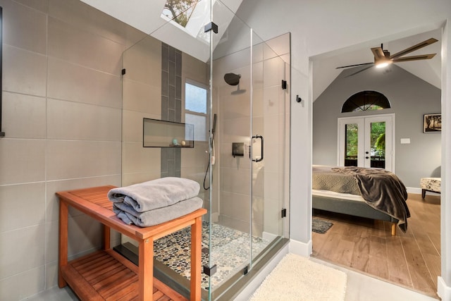 bathroom featuring an enclosed shower, hardwood / wood-style flooring, vaulted ceiling, and french doors