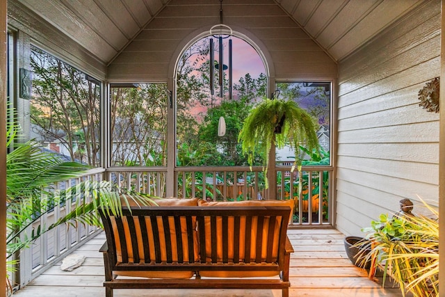 sunroom featuring vaulted ceiling