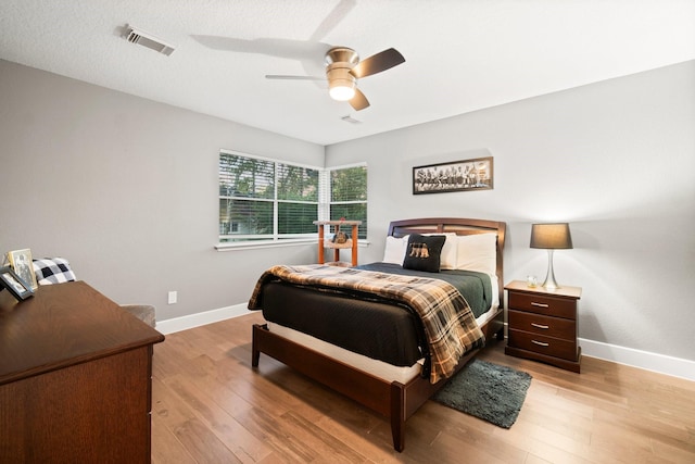 bedroom with ceiling fan and light hardwood / wood-style flooring