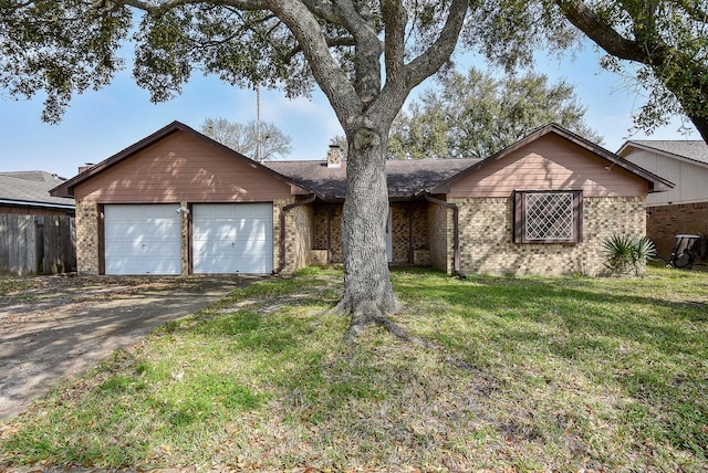 ranch-style house with driveway, brick siding, an attached garage, and a front yard