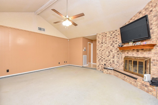 unfurnished living room with visible vents, carpet floors, a fireplace, and vaulted ceiling with beams