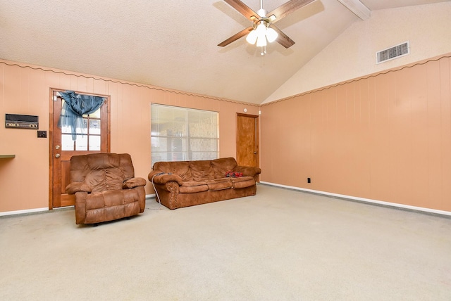 carpeted living area featuring lofted ceiling with beams, visible vents, a textured ceiling, and a ceiling fan