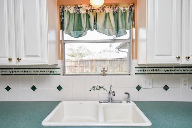 kitchen featuring a sink, a wealth of natural light, and white cabinets