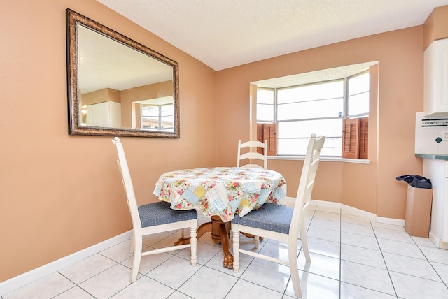 dining room with light tile patterned floors and baseboards