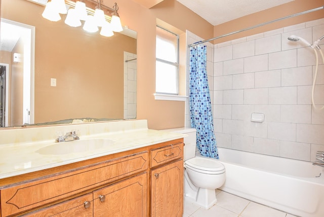 bathroom featuring tile patterned flooring, toilet, shower / tub combo with curtain, a textured ceiling, and vanity