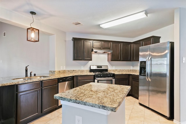 kitchen with light tile patterned flooring, sink, hanging light fixtures, kitchen peninsula, and stainless steel appliances