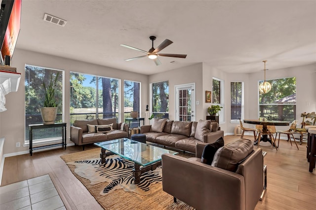 living room featuring light hardwood / wood-style flooring and ceiling fan