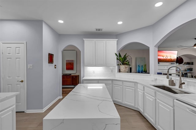 kitchen with sink, white cabinetry, tasteful backsplash, a center island, and dishwasher