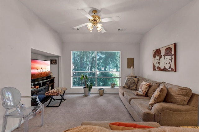 living room with lofted ceiling, ceiling fan, and carpet flooring