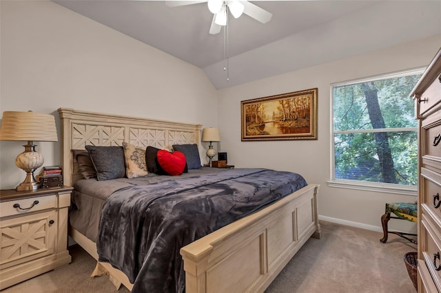 bedroom with vaulted ceiling, light colored carpet, and ceiling fan