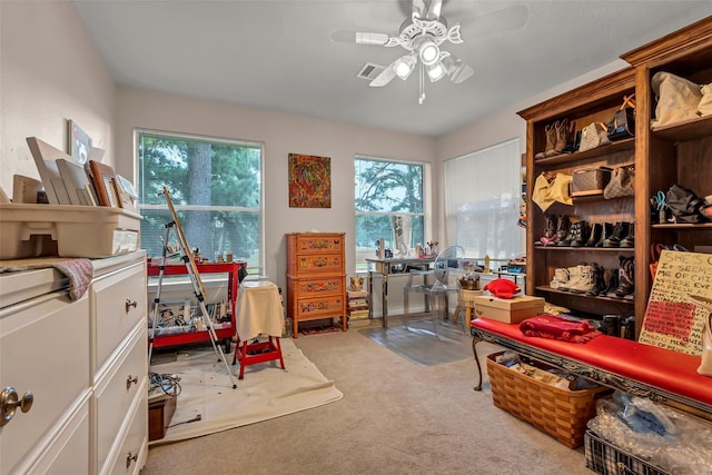 carpeted office featuring ceiling fan