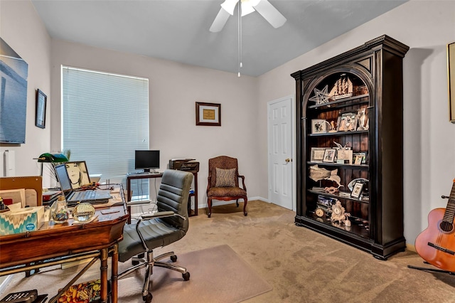 carpeted office space featuring ceiling fan