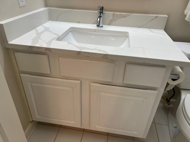 bathroom featuring tile patterned flooring, vanity, and toilet