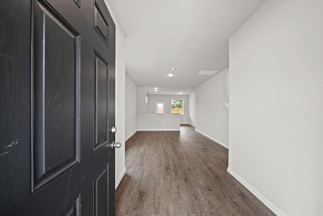 entryway with dark wood-style floors, visible vents, and baseboards