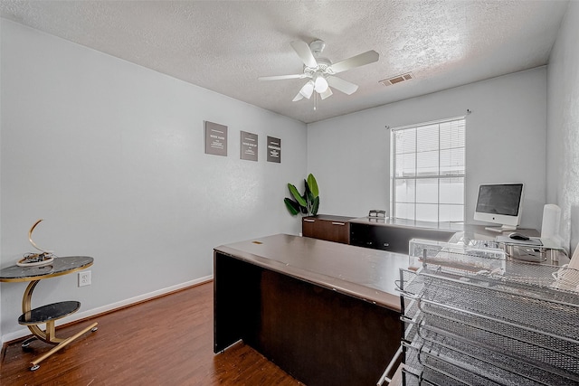 office with a textured ceiling, wood-type flooring, and ceiling fan