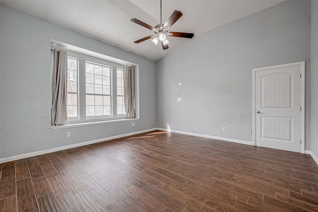 empty room featuring dark hardwood / wood-style flooring, lofted ceiling, and ceiling fan