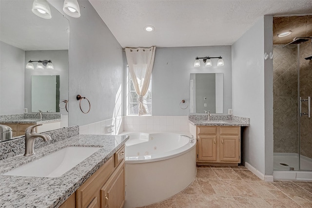 bathroom with vanity, plus walk in shower, and a textured ceiling