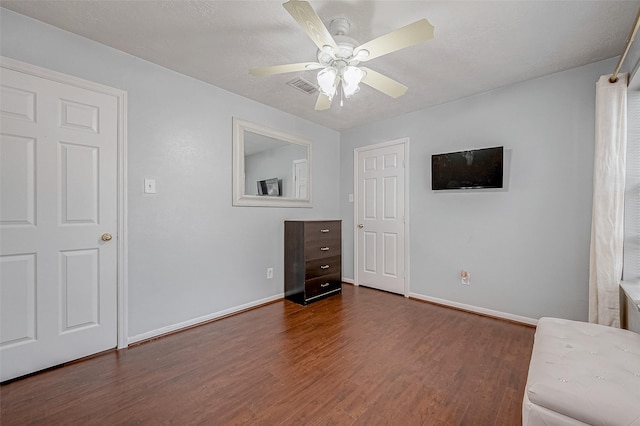 interior space featuring ceiling fan and dark hardwood / wood-style flooring