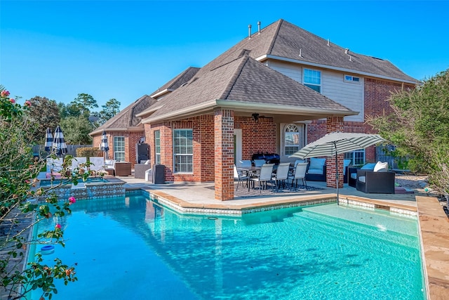 exterior space featuring ceiling fan, an outdoor hot tub, and a patio