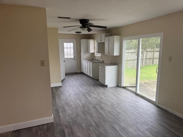 kitchen with white cabinetry, sink, dark wood-type flooring, and ceiling fan