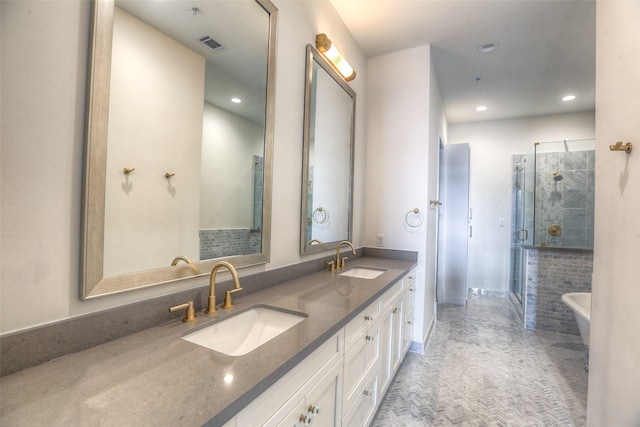 bathroom with vanity and separate shower and tub