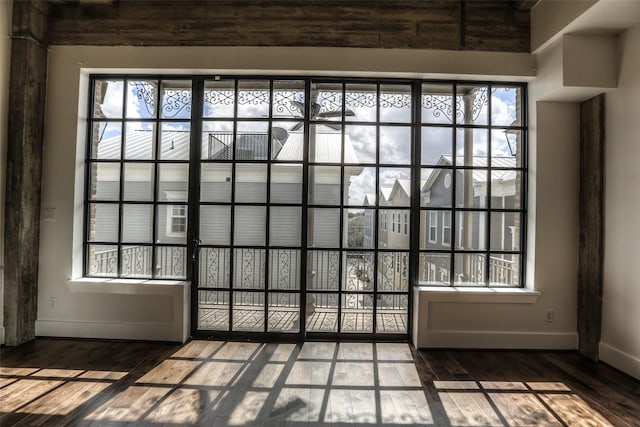 doorway with hardwood / wood-style floors and a healthy amount of sunlight