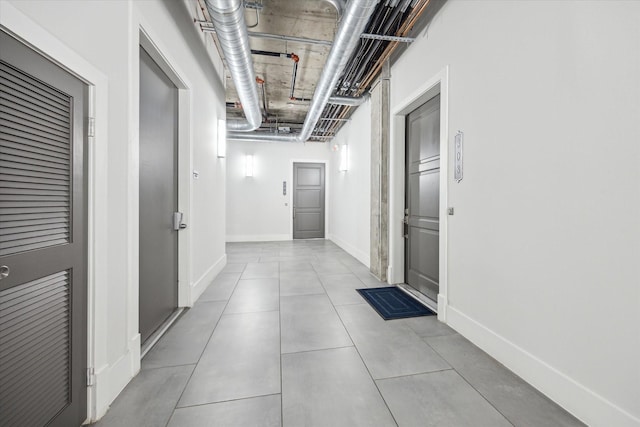 1714 Ashland Unit 303, Houston, TX 77008 - hallway featuring baseboards and tile patterned floors