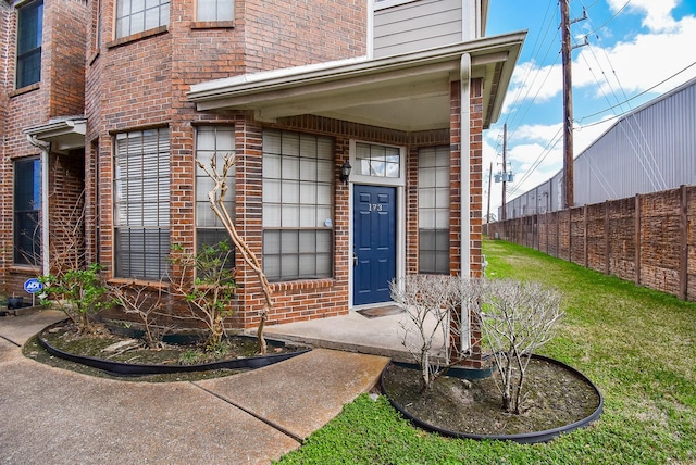 doorway to property featuring a yard