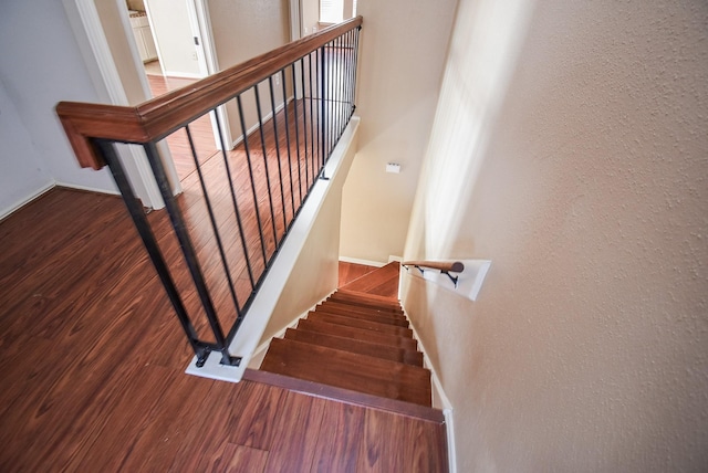 stairway featuring hardwood / wood-style floors