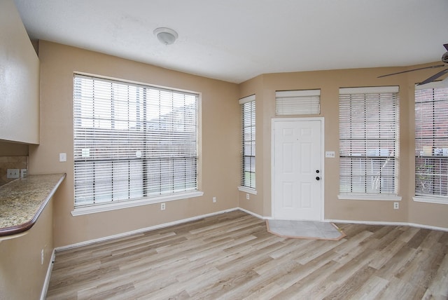 entrance foyer featuring light hardwood / wood-style flooring and ceiling fan