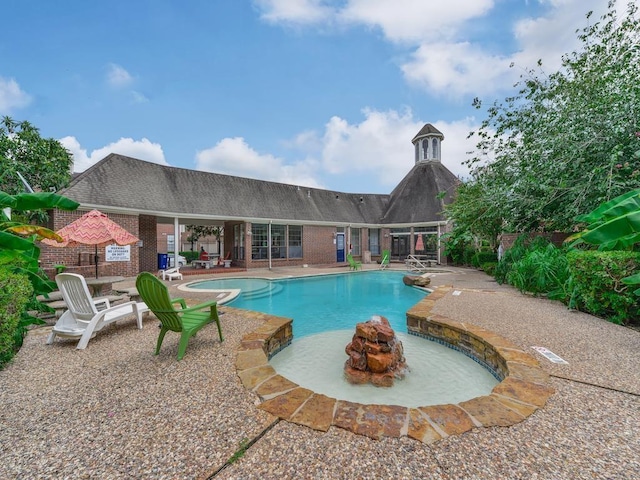 view of pool featuring a patio