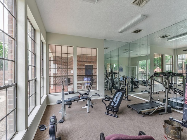 exercise room with a textured ceiling