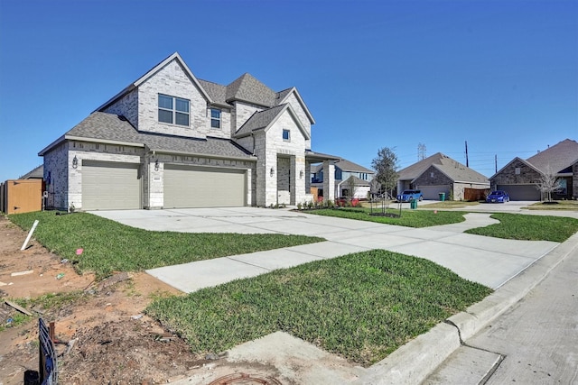 french country home featuring a front yard, a residential view, driveway, and a shingled roof