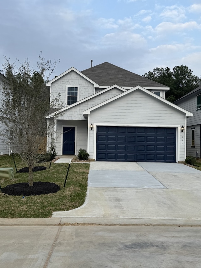 view of front property featuring a garage and central AC unit