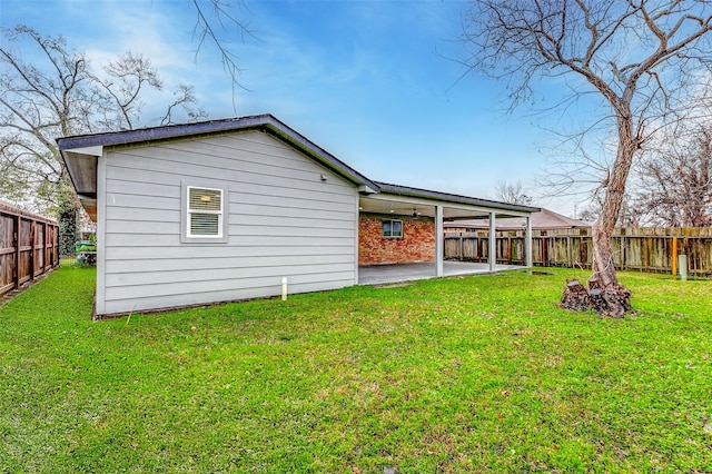 back of house with a patio and a yard