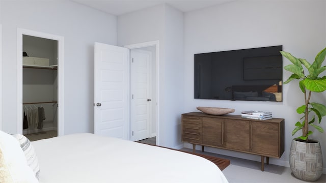 bedroom featuring a spacious closet and a closet